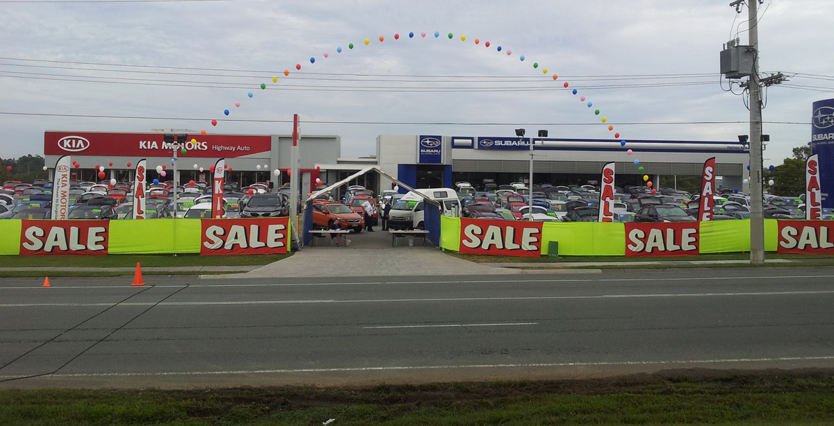 Ultimate Events - Mega Event Sale at car dealership with balloons and sale banners